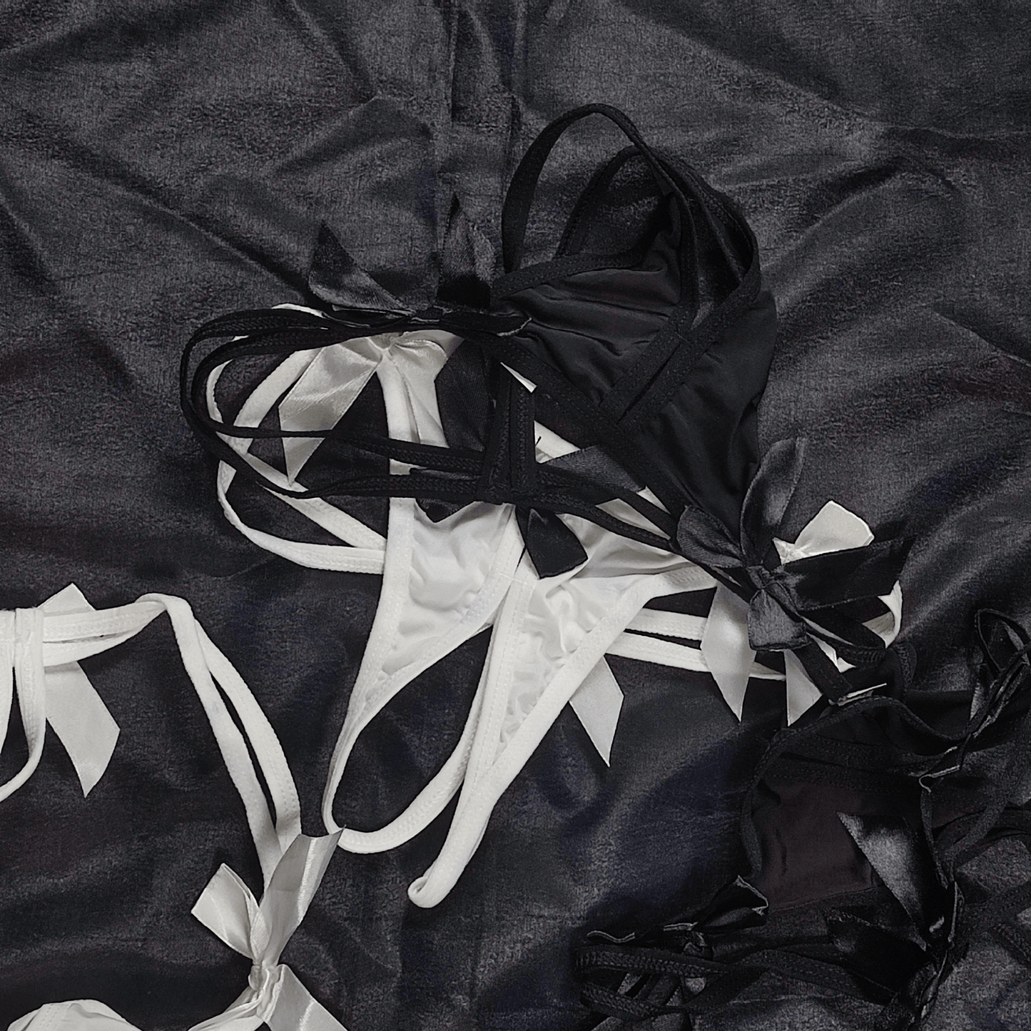 Pack of 2 Bow Strappy Thong in Snow White and Classic Black with satin bows, showcasing elegant and playful design.