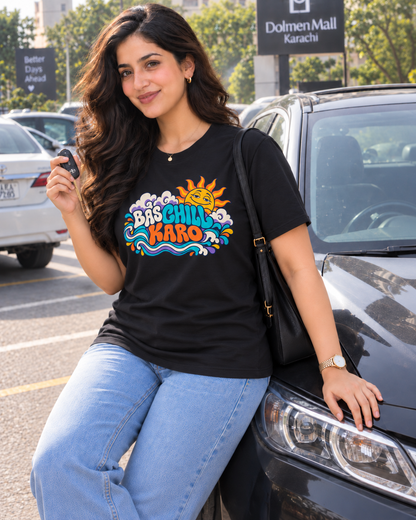 BAS CHILL KARO black unisex T-shirt by ComfyBliss, model seated, centred horizontal front print